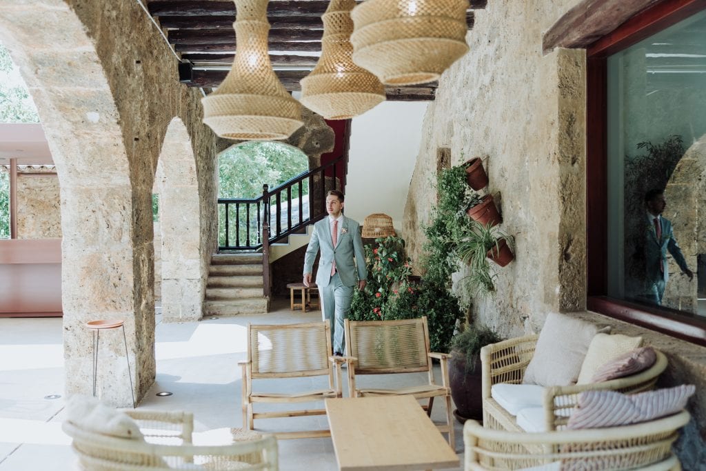 Decoración de boda atípica en espacio rústico con muebles de madera y plantas verdes.