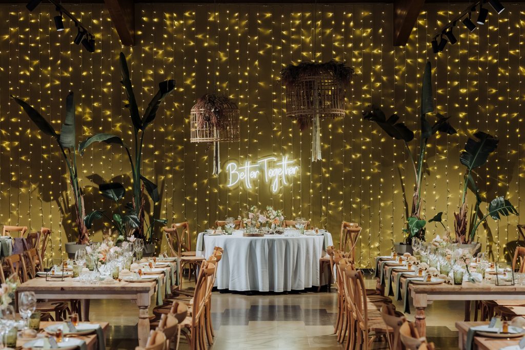 Decoración de boda con luces cálidas y detalles naturales en un ambiente íntimo.
