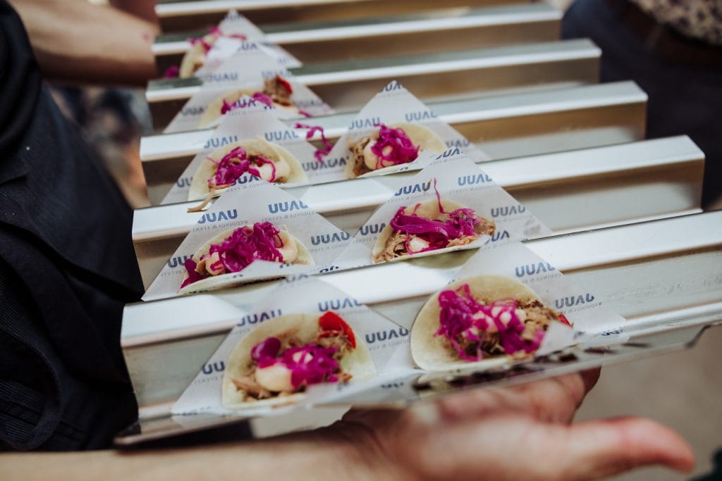 Bocadillos de boda con flores comestibles en una bandeja para eventos especiales.